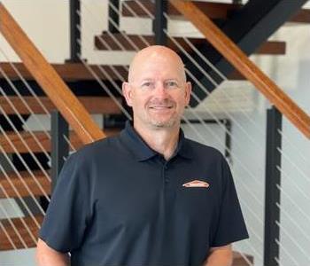 male employee in front of wall