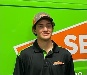 man in front of a green van